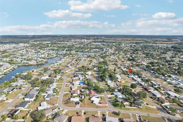 an aerial view of residential houses with city view