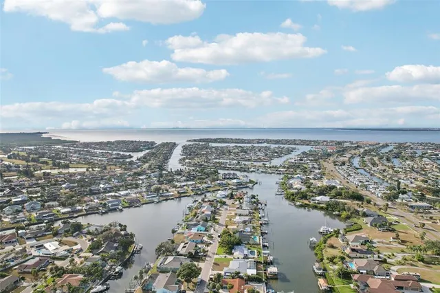 a swimming pool with yard in front of it