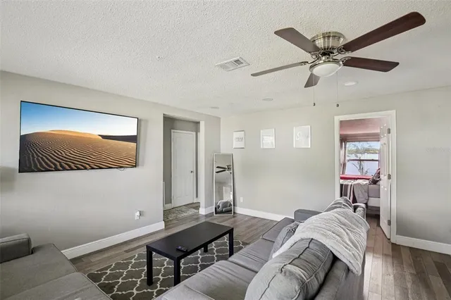 a living room with furniture and a wooden floor