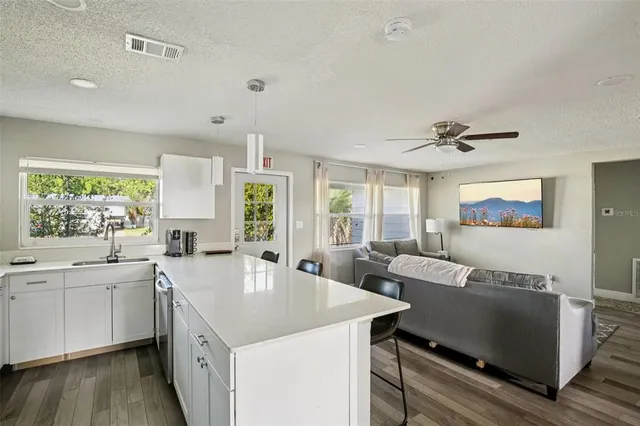 a kitchen with sink and large window