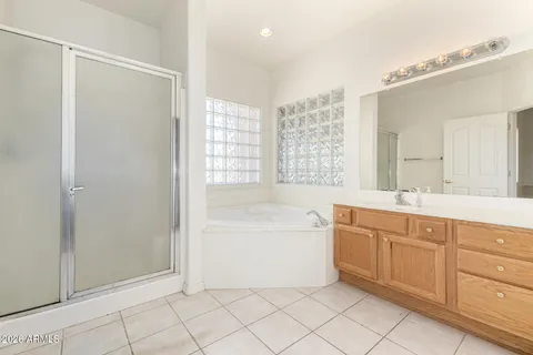 a spacious bathroom with a mirror a shower and a bathtub