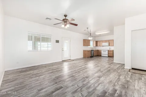 a view of a room with wooden floor and windows