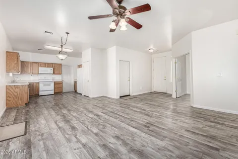 a view of a kitchen with furniture and a ceiling fan
