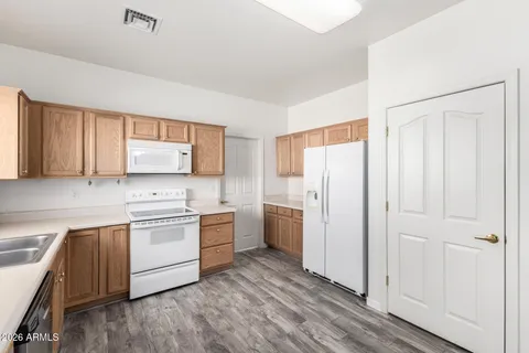 a kitchen with white cabinets and white appliances