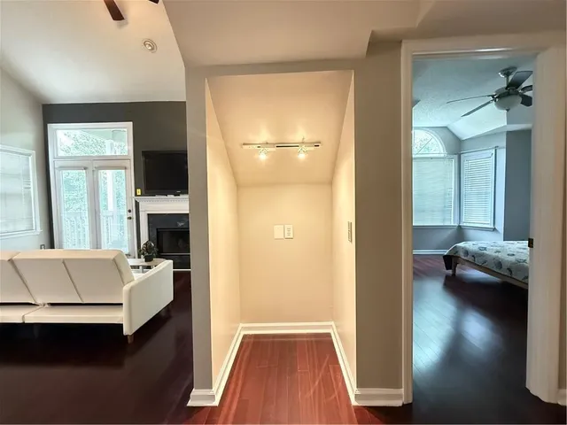 a hallway with a couch and chandelier