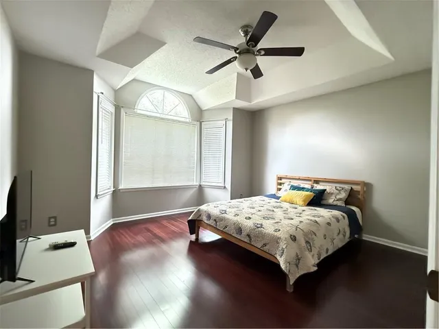 a bedroom with a bed and a large window
