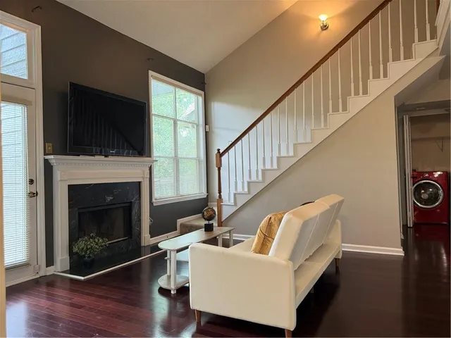 a living room with furniture fireplace and flat screen tv