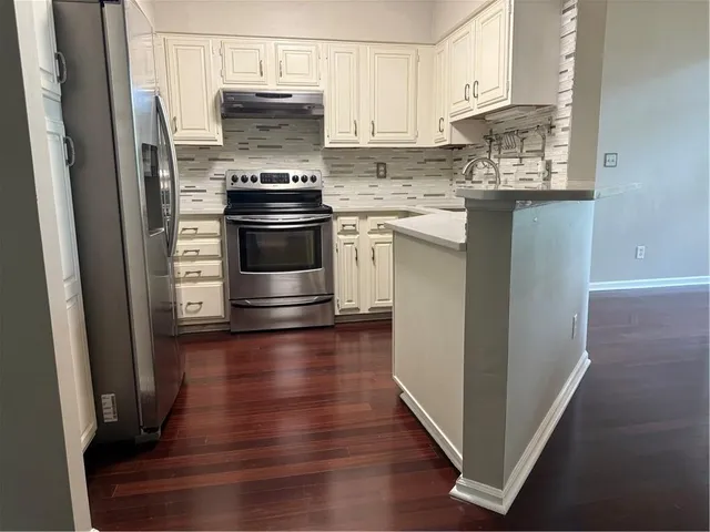 a kitchen with granite countertop a stove and a sink