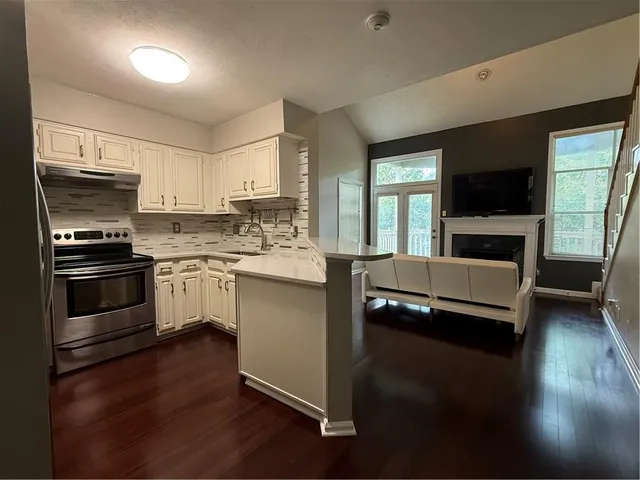 a kitchen with a sink appliances and cabinets