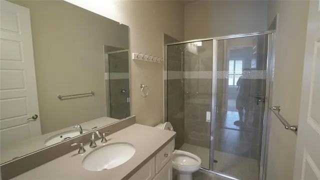 a bathroom with a sink toilet and shower