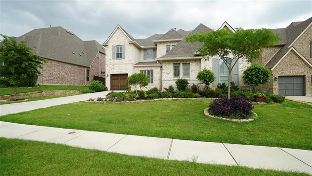 a front view of a house with a garden and plants