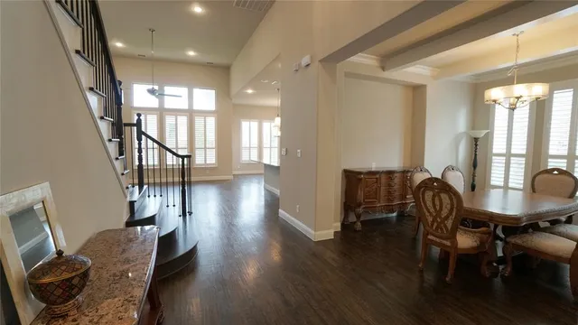 a dining room with furniture window and wooden floor