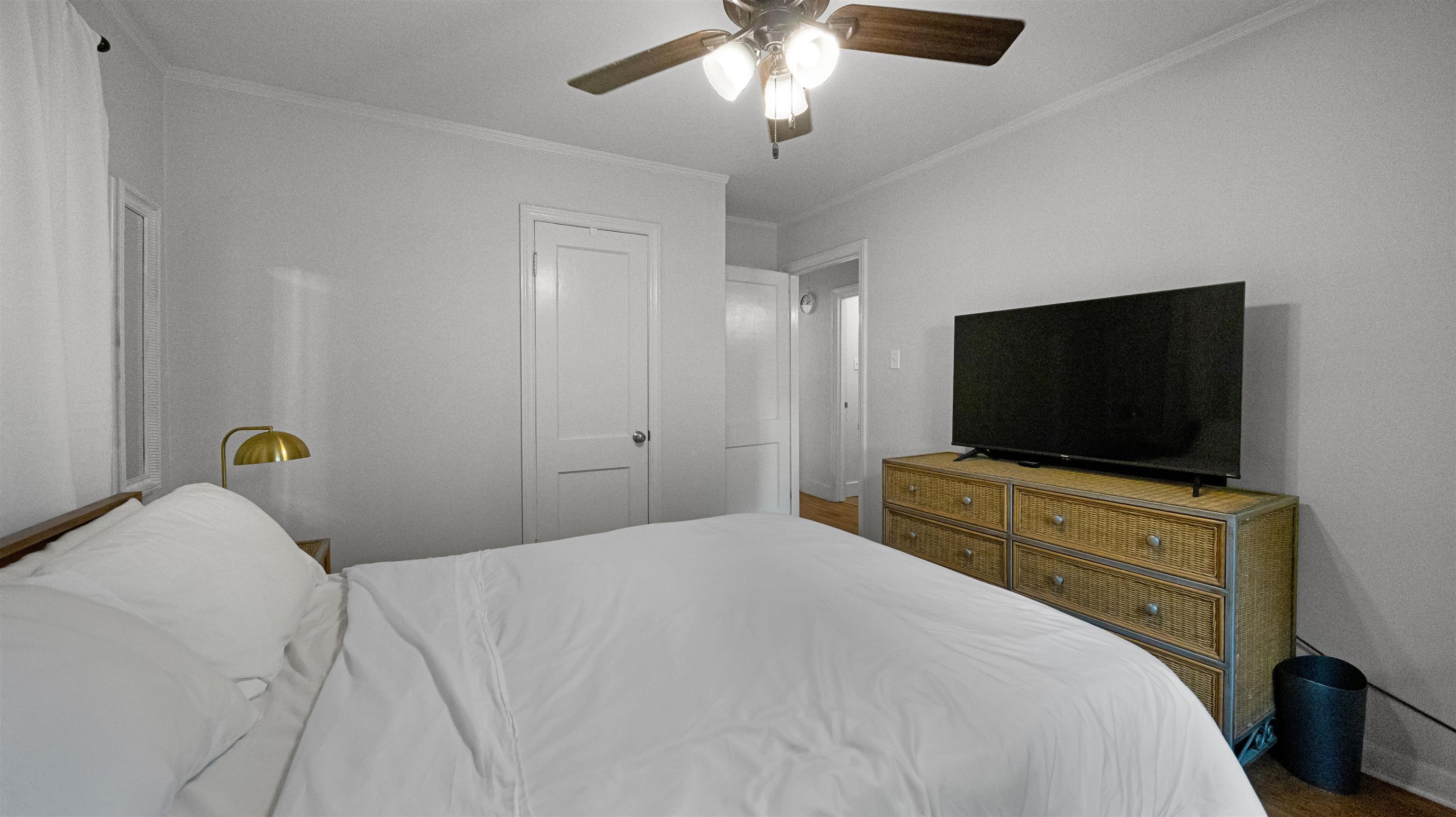 144 Sycamore Road Collierville, TN 38017 - Photo 7 of 11 a bedroom with a bed and a flat screen tv