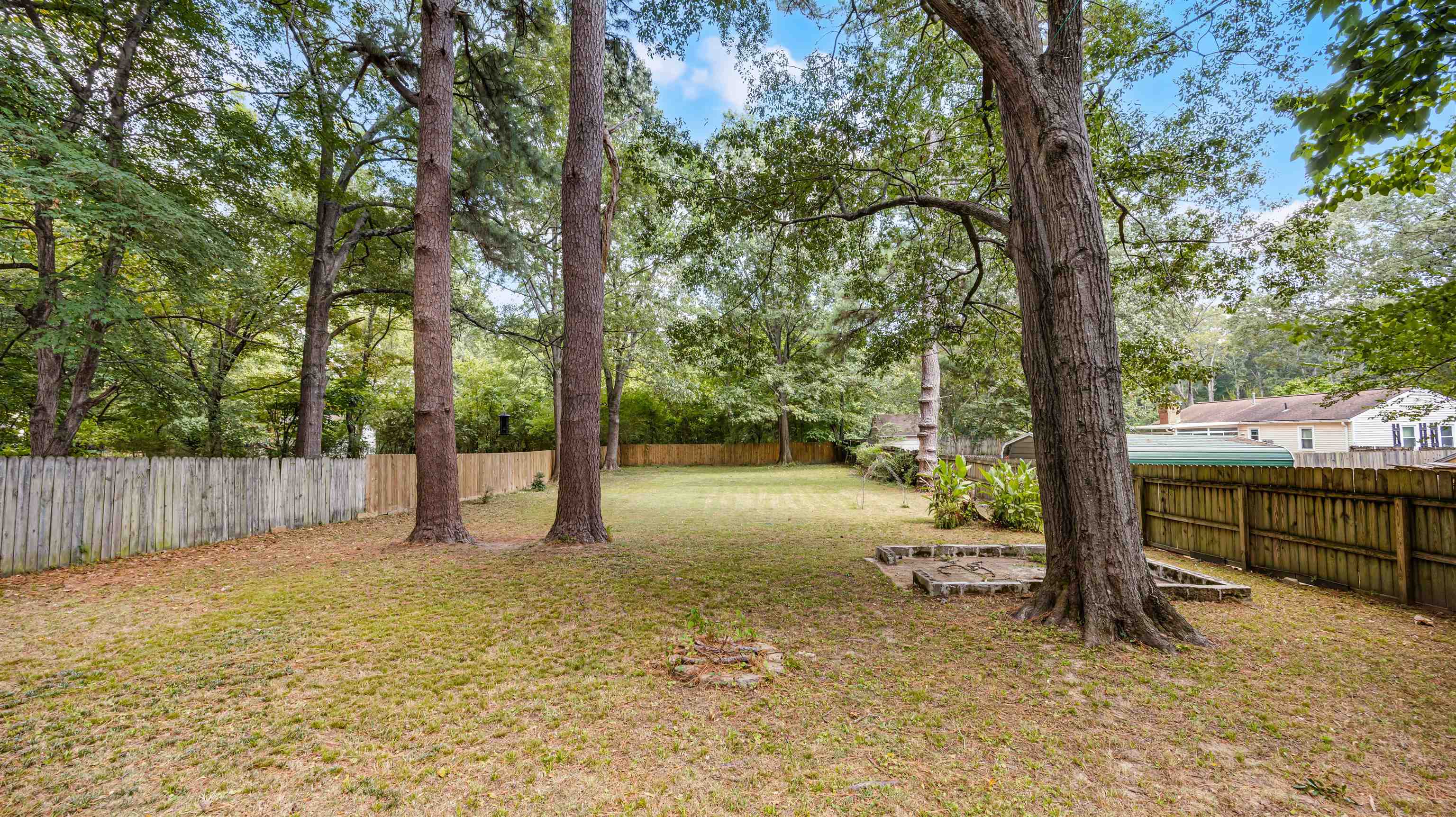 144 Sycamore Road Collierville, TN 38017 - Photo 9 of 11 a view of a backyard with large trees and a barn
