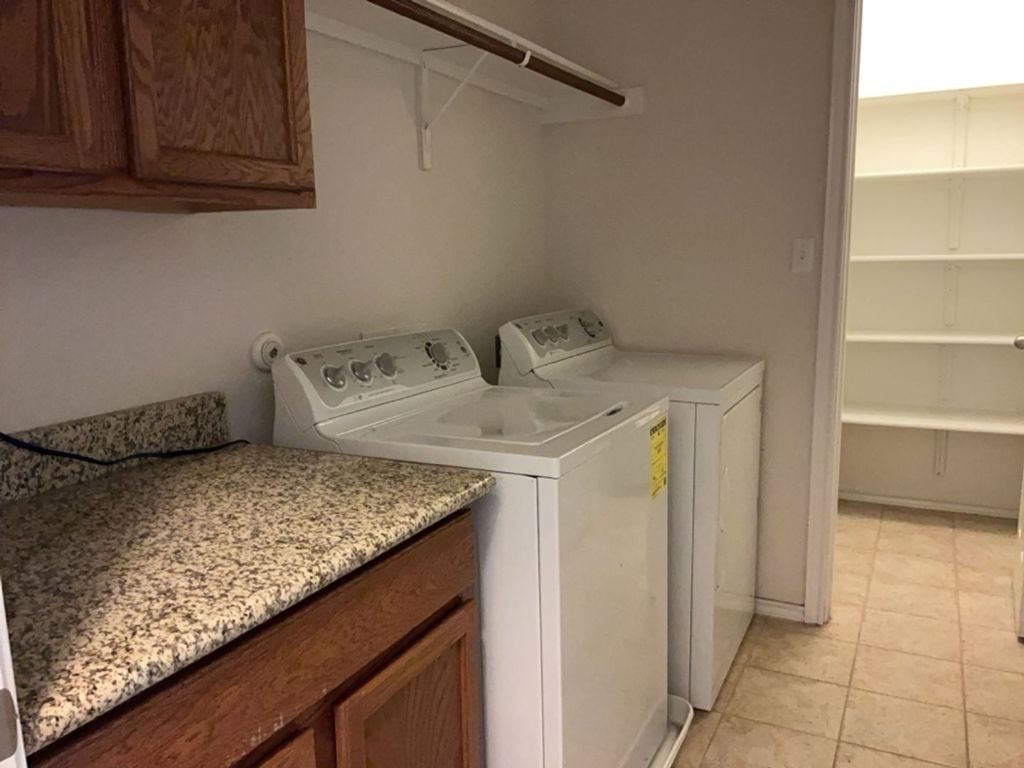 2105 Town Centre Drive, Unit 28 Round Rock, TX 78664 - Photo 16 of 28 Laundry area with storage space, washer and dryer