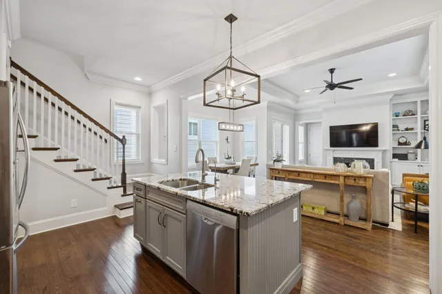 a kitchen with sink cabinets and chairs