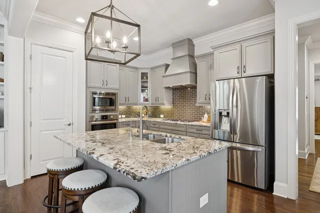 a living room with furniture a flat screen tv and a dining table