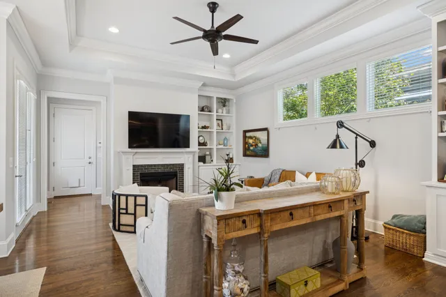 a living room with furniture a fireplace and a flat screen tv