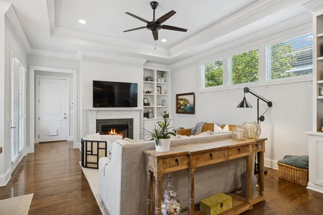 a living room with furniture a fireplace and a flat screen tv