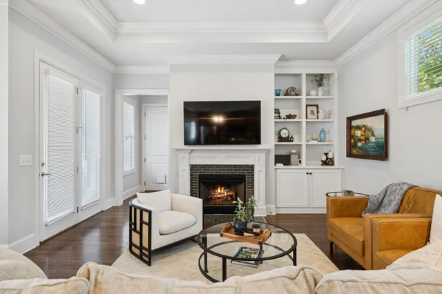 a living room with furniture a flat screen tv and a fireplace