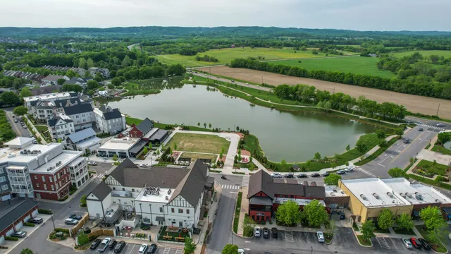 an aerial view of a houses with a yard