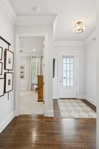 a kitchen with stainless steel appliances granite countertop a refrigerator a sink dishwasher a oven with white cabinets and wooden floor