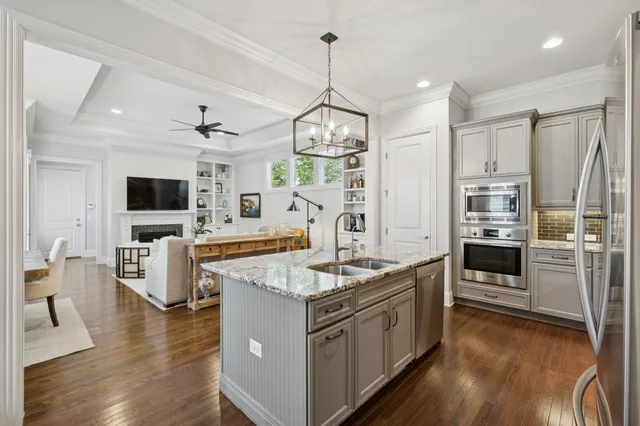 a open kitchen with stainless steel appliances granite countertop a stove and a sink