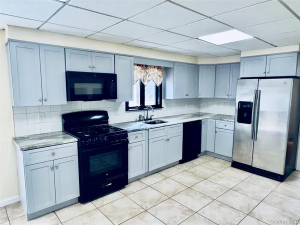 a kitchen with a sink cabinets and stainless steel appliances