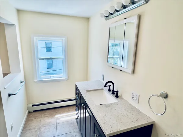 a bathroom with a sink a vanity and a mirror