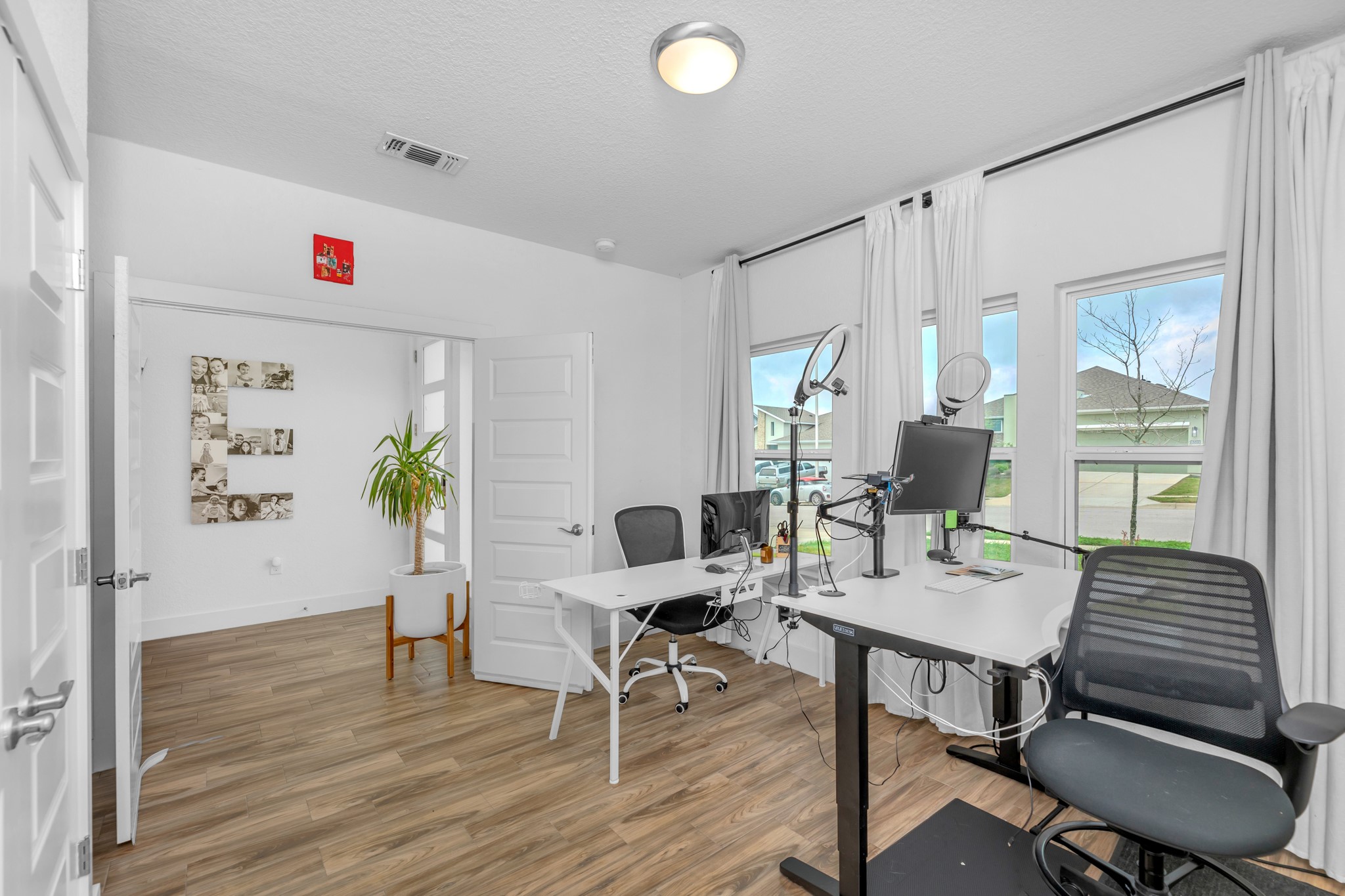 16512 Fetching Avenue Manor, TX 78653 - Photo 26 of 39 Office space featuring visible vents, baseboards, a textured ceiling, and wood finished floors