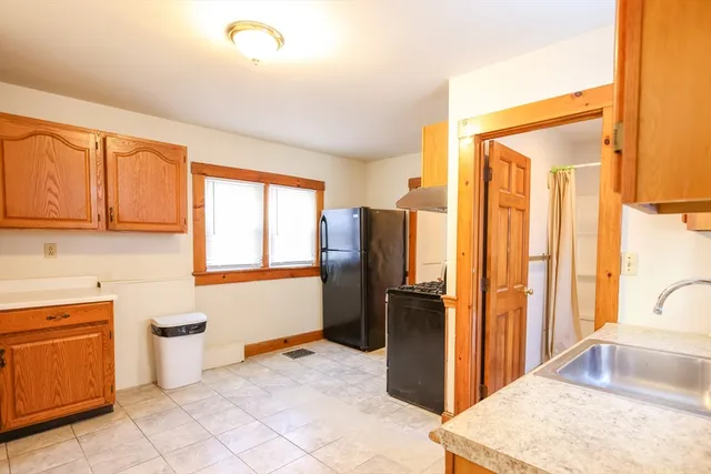 a kitchen with stainless steel appliances granite countertop a refrigerator and a sink