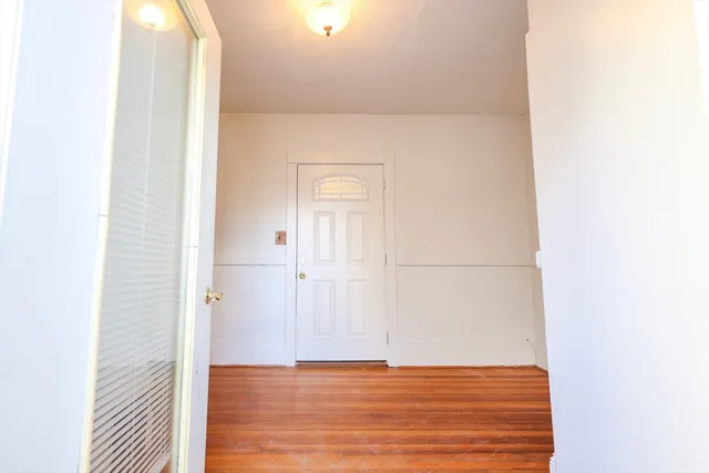 a view of a room with wooden floor