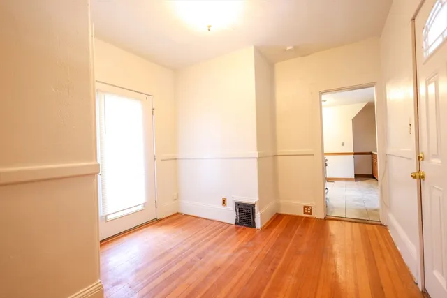 a view of a room with wooden floor and a window