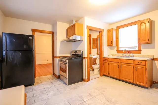 a kitchen with stainless steel appliances granite countertop a refrigerator and a sink