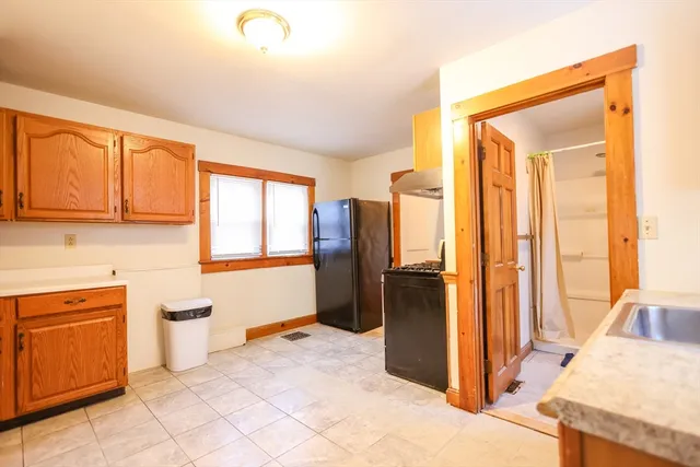 a kitchen with a window a sink and a refrigerator