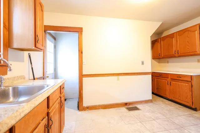 a kitchen with granite countertop a sink and a stove top oven