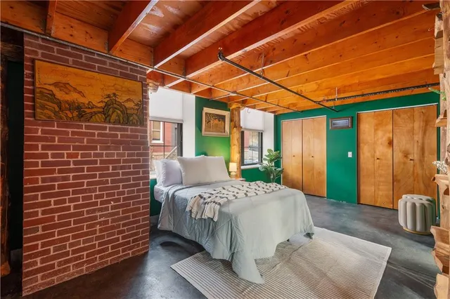 a bedroom with a bed and a mirror