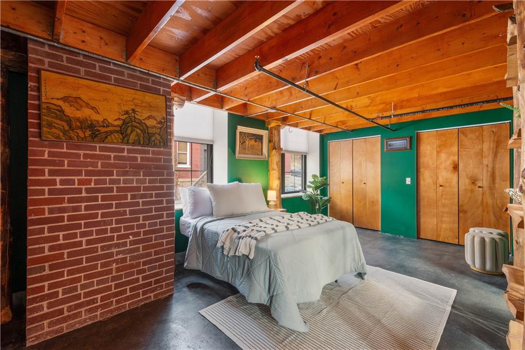 1536 Colwell Street, Unit 4 Pittsburgh, PA 15219 - Photo 13 of 43 a bedroom with a bed and a mirror