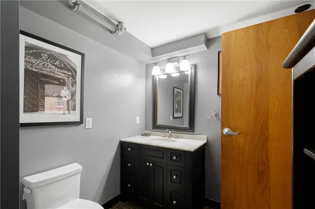 a bathroom with a toilet sink and mirror
