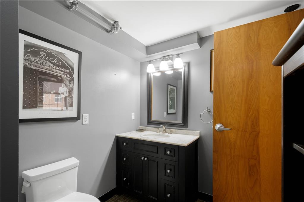 1536 Colwell Street, Unit 4 Pittsburgh, PA 15219 - Photo 15 of 43 a bathroom with a toilet sink and mirror