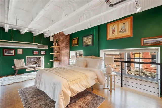 a bed room with a bed window and table chair