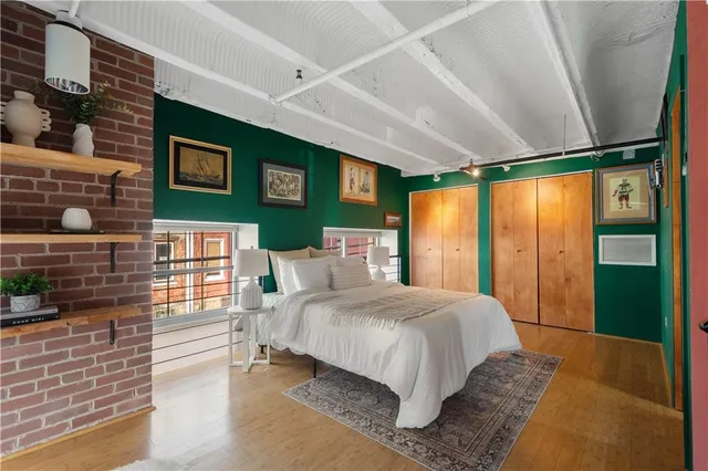 a bedroom with a large bed and a window