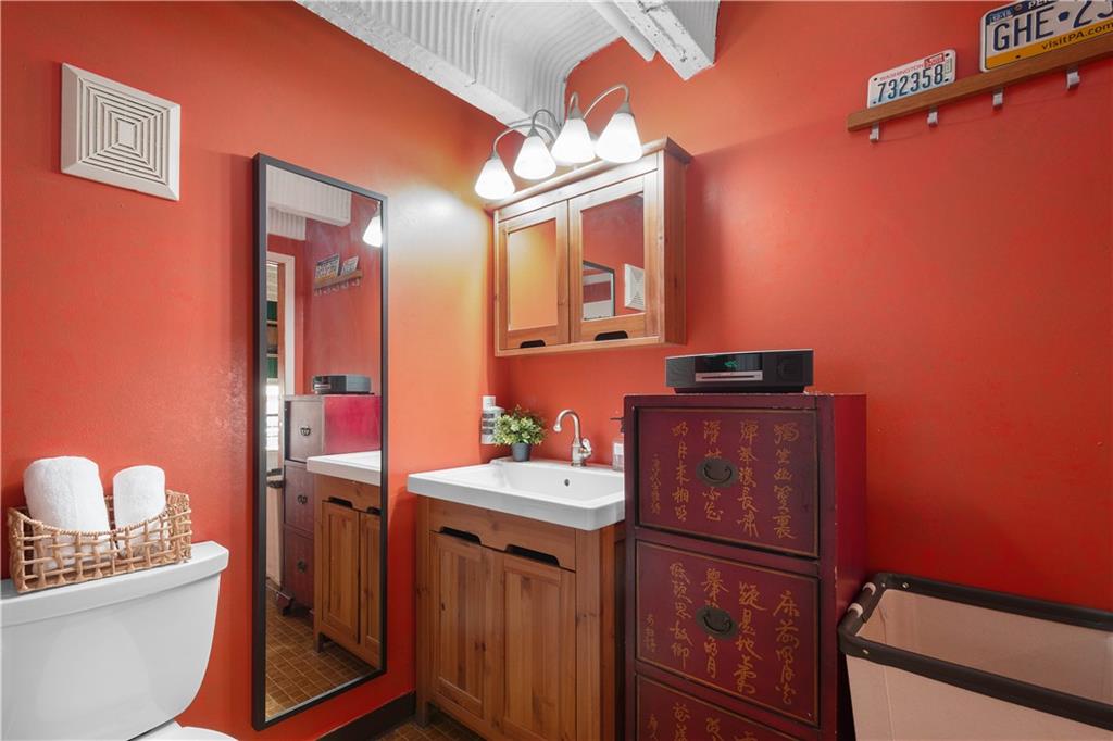 1536 Colwell Street, Unit 4 Pittsburgh, PA 15219 - Photo 24 of 43 a bathroom with a sink a toilet and mirror