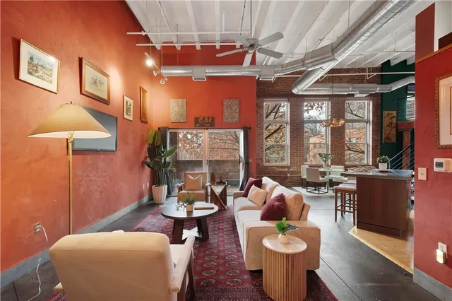 a living room with patio furniture and a large window