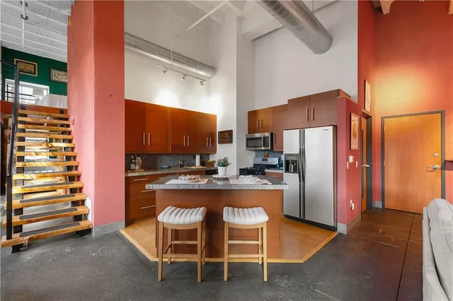 a kitchen with refrigerator and cabinets