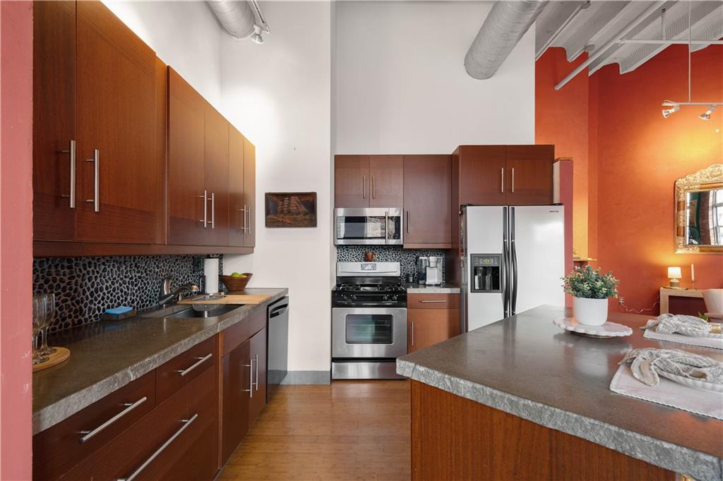 1536 Colwell Street, Unit 4 Pittsburgh, PA 15219 - Photo 7 of 43 a kitchen with stainless steel appliances granite countertop a sink stove and refrigerator