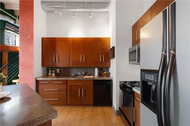 a kitchen with a sink stove and refrigerator