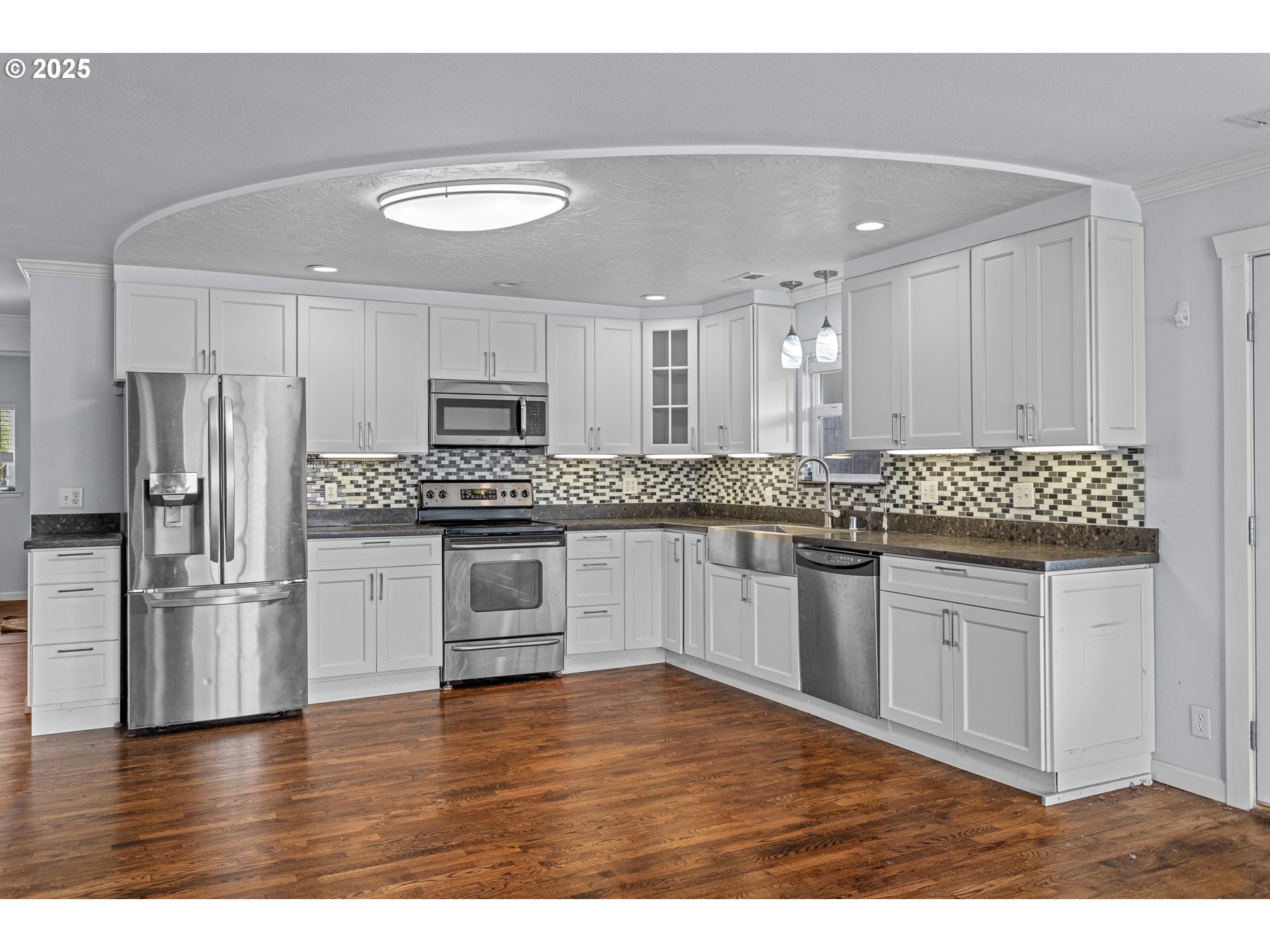 1713 Maple Street Myrtle Point, OR 97458 - Photo 11 of 43 a kitchen with granite countertop white cabinets and stainless steel appliances