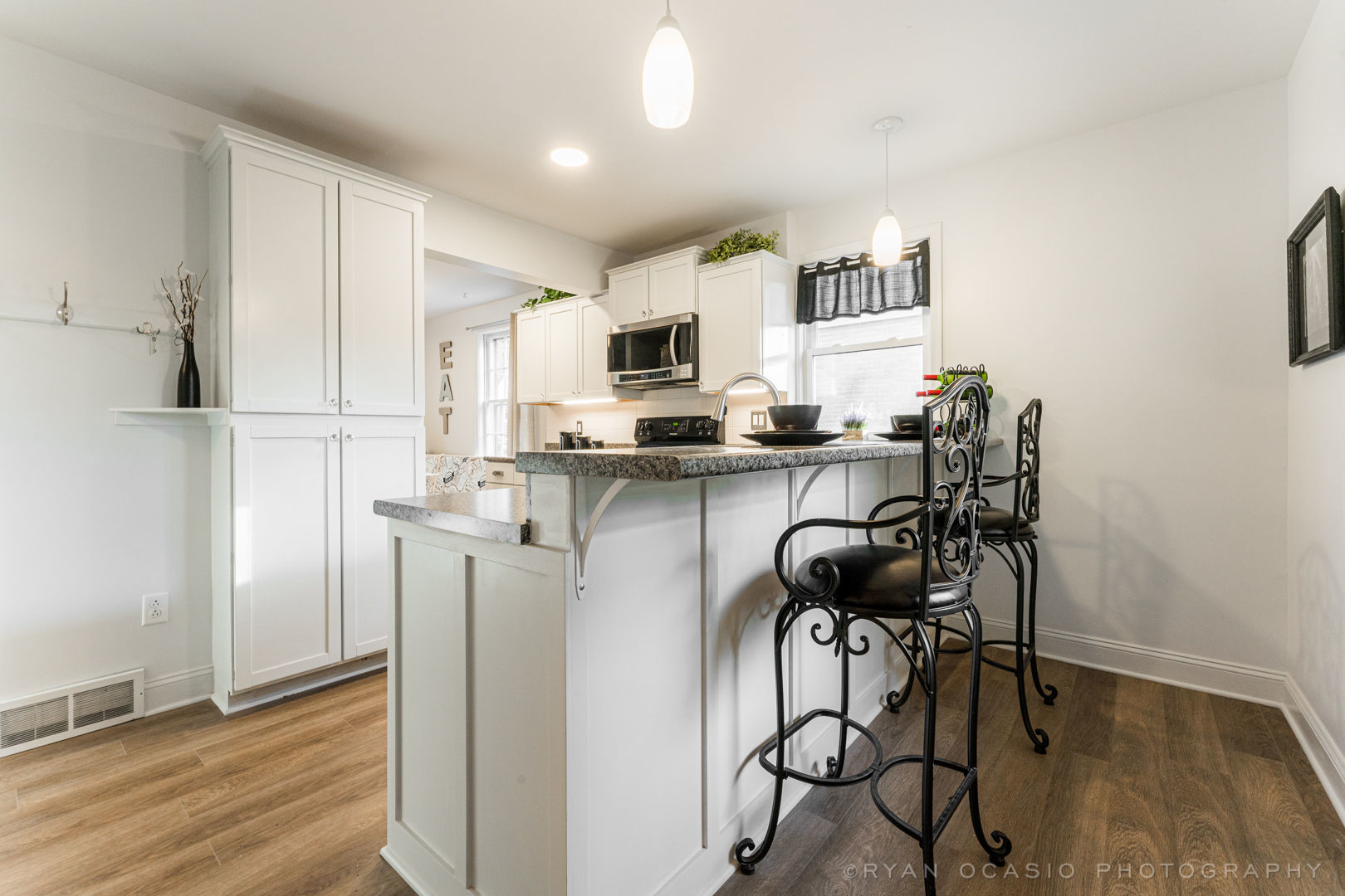523 Kendall Lane DeKalb, IL 60115 - Photo 10 of 29 a kitchen with stainless steel appliances a stove a refrigerator and a dining table with wooden floor