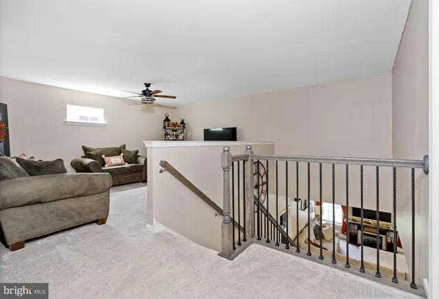 a living room with furniture a air conditioner and a rug